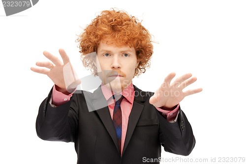 Image of businessman working with something imaginary