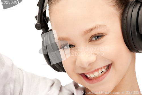 Image of happy teenage girl in big headphones