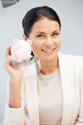 Image of lovely woman with piggy bank