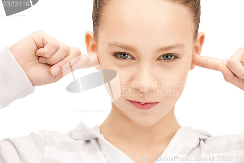 Image of teenage girl with fingers in ears