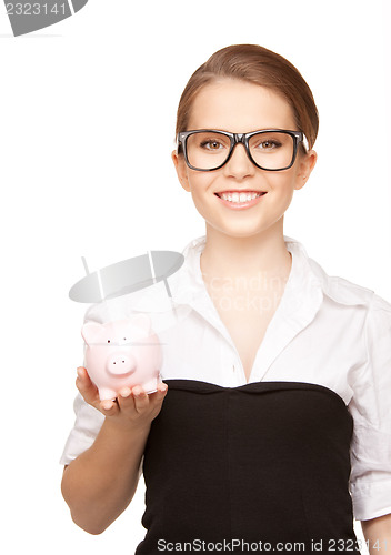 Image of lovely woman with piggy bank