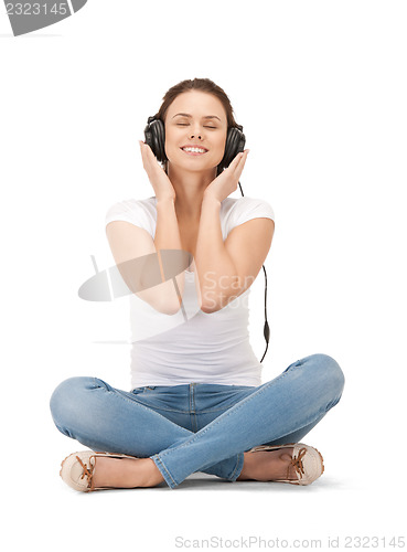 Image of happy teenage girl in big headphones