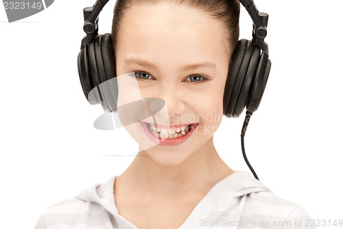 Image of happy teenage girl in big headphones