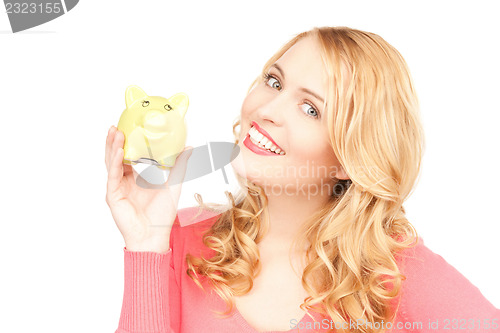 Image of lovely woman with piggy bank