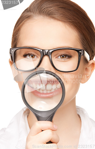 Image of woman with magnifying glass showing teeth