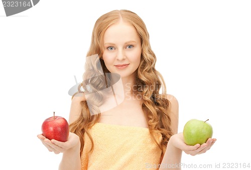 Image of young beautiful woman with green and red apples