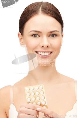 Image of young beautiful woman with pills