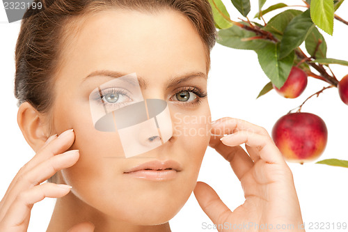 Image of lovely woman with apple twig