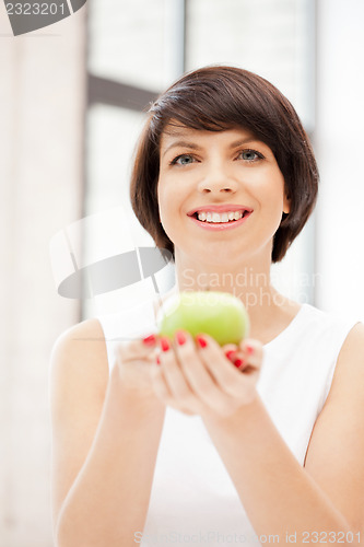 Image of lovely housewife with green apple