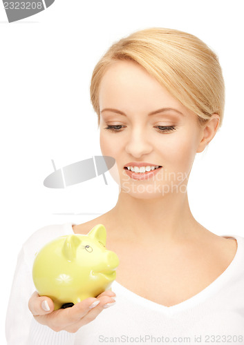 Image of lovely woman with piggy bank