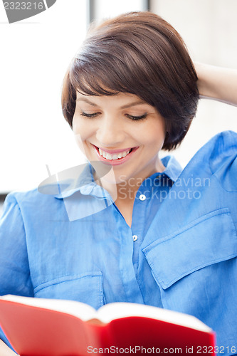 Image of happy and smiling woman with book