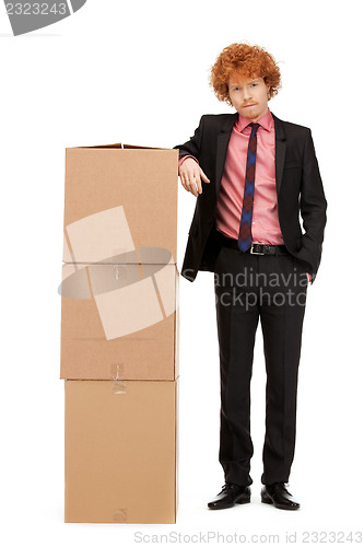 Image of attractive businessman with big boxes