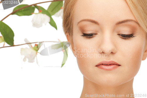 Image of beautiful woman with orchid flower