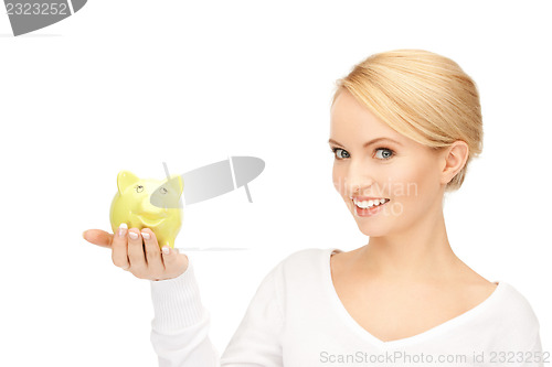 Image of lovely woman with piggy bank