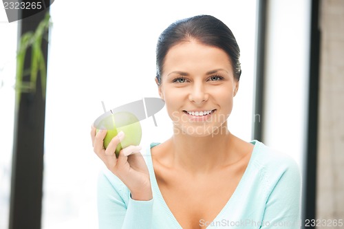 Image of lovely housewife with green apple