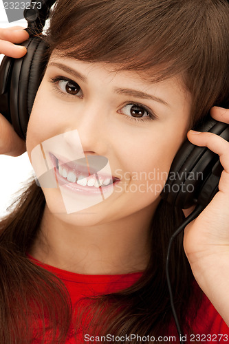 Image of happy teenage girl in big headphones