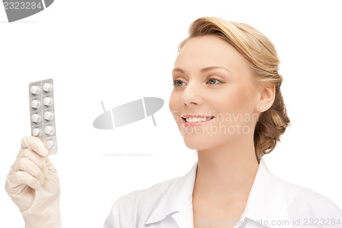 Image of attractive female doctor with pills