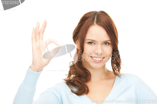 Image of lovely teenage girl showing ok sign