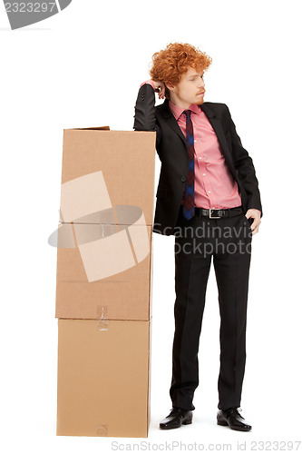 Image of attractive businessman with big boxes