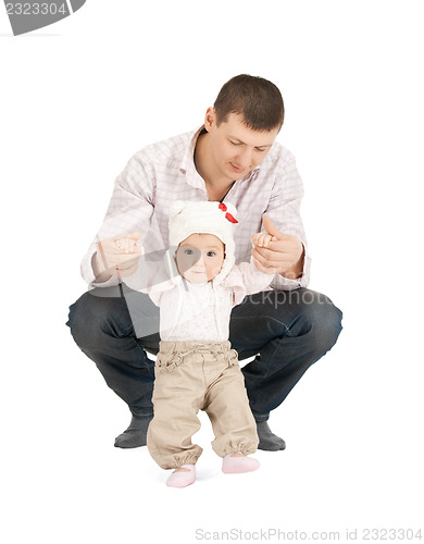 Image of baby making first steps with father help