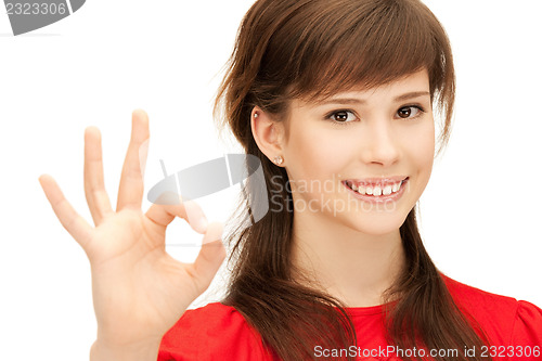 Image of lovely teenage girl showing ok sign