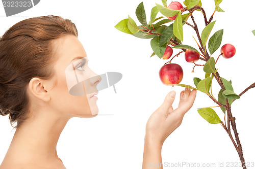 Image of lovely woman with apple twig