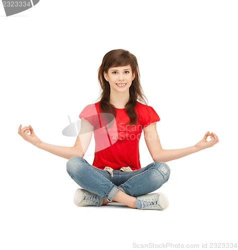 Image of happy and carefree teenage girl in lotus pose