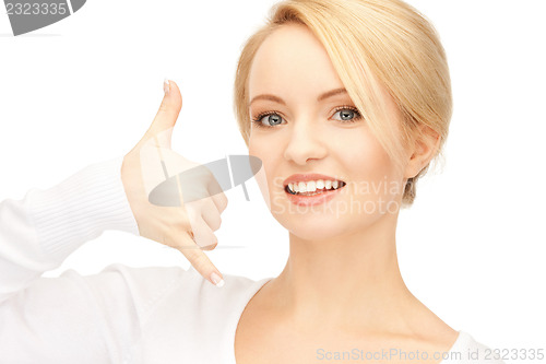 Image of woman making a call me gesture
