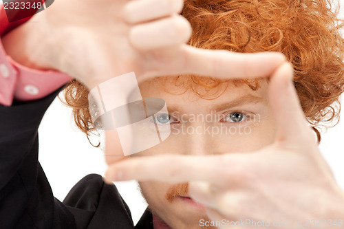 Image of handsome man creating a frame with fingers