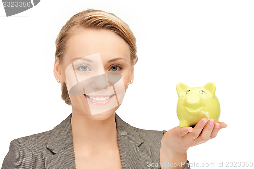 Image of lovely woman with piggy bank