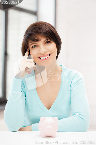 Image of lovely woman with piggy bank