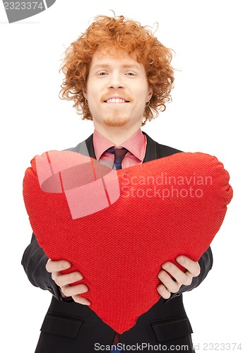 Image of handsome man with red heart-shaped pillow