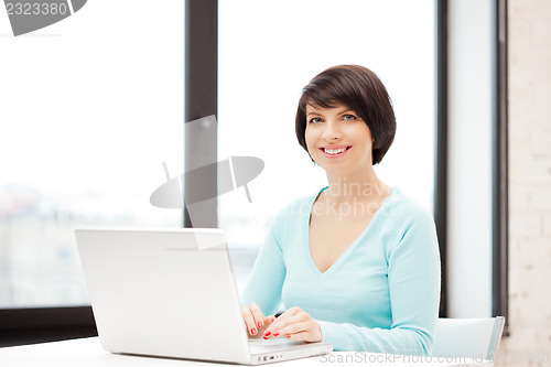 Image of happy woman with laptop computer