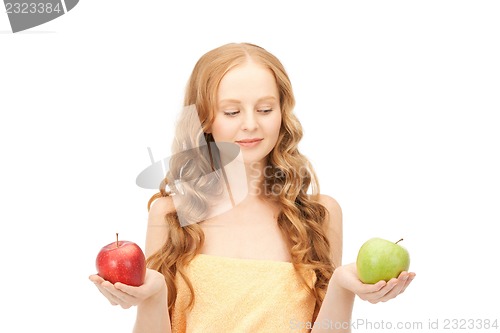 Image of young beautiful woman with green and red apples