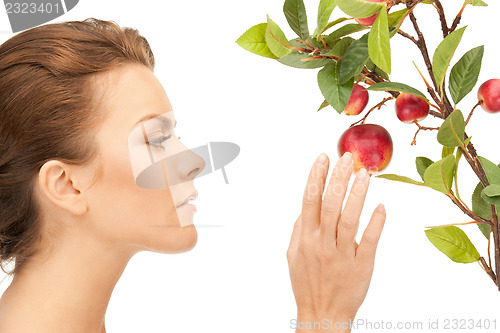 Image of lovely woman with apple twig