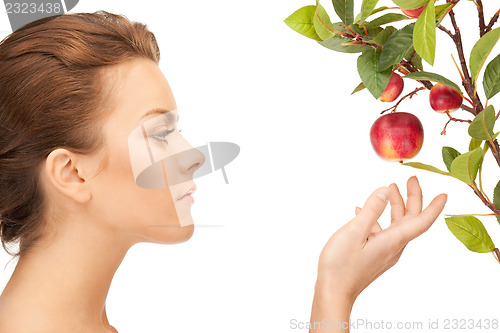 Image of lovely woman with apple twig