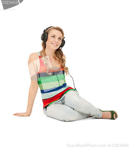 Image of happy teenage girl in big headphones