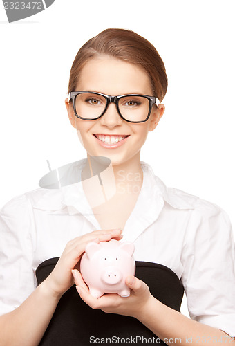 Image of lovely woman with piggy bank