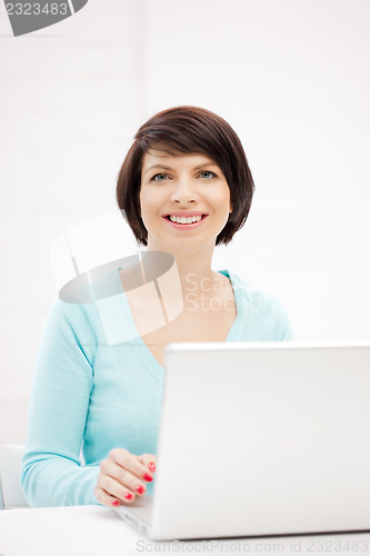 Image of happy woman with laptop computer