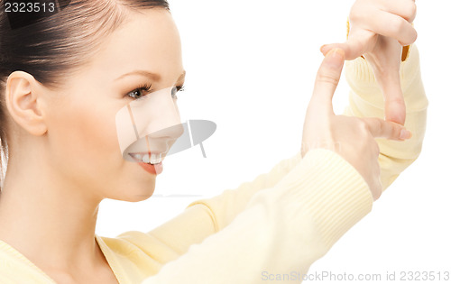 Image of lovely woman creating a frame with fingers