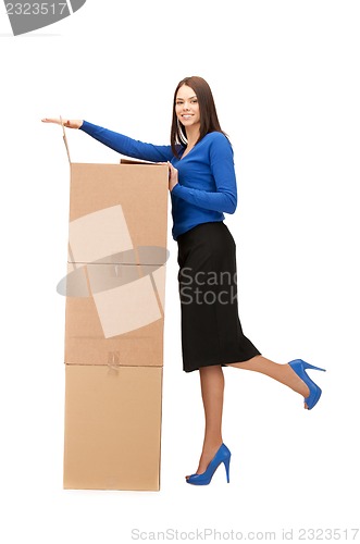 Image of attractive businesswoman with big boxes