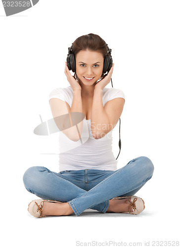 Image of happy teenage girl in big headphones