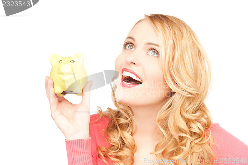 Image of lovely woman with piggy bank