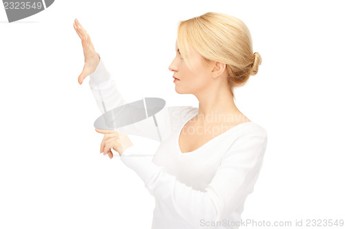 Image of businesswoman working with something imaginary