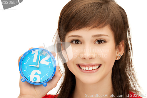 Image of teenage girl holding alarm clock