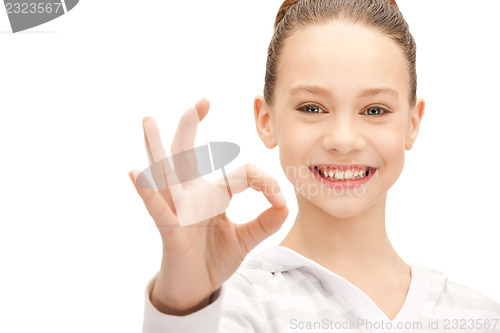 Image of lovely teenage girl showing ok sign