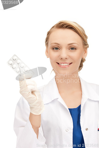 Image of attractive female doctor with pills