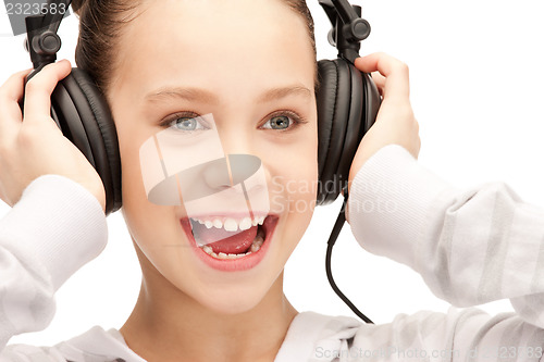 Image of happy teenage girl in big headphones