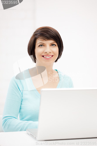 Image of happy woman with laptop computer