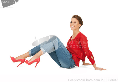 Image of lovely woman in red blouse and jeans